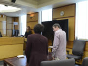 Brent Luyster III rubs his head in shock after he was acquitted of second-degree murder Tuesday in Clark County Superior Court. The jury deliberated for about 2 1/2  hours before returning the not-guilty verdict.