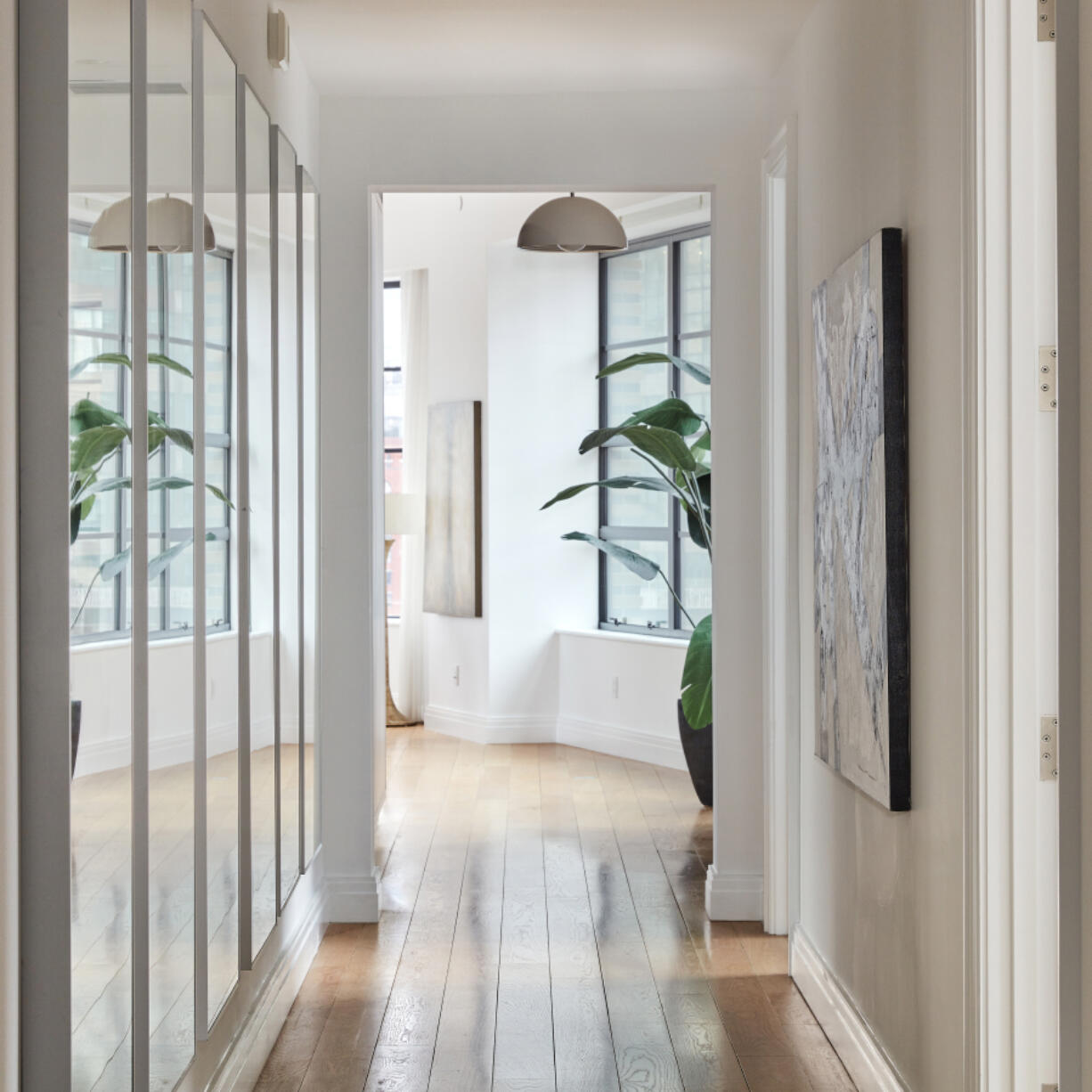 A long series of mirrors is used to help reflect light in a long hallway.