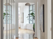 A long series of mirrors is used to help reflect light in a long hallway.