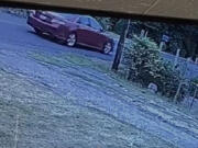 The stolen red 2010 Toyota Camry, seen on surveillance footage fleeing the area, has Washington license plate BKP4080 and should have damage to the front or front passenger's side, the Clark County Sheriff's Office said.