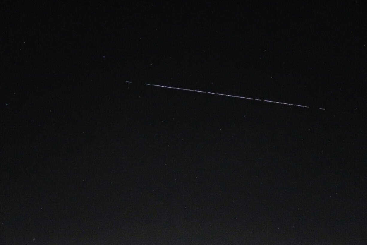 A Starlink-55 satellite train is seen Saturday night over the National Weather Service in Seattle.