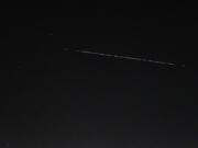 A Starlink-55 satellite train is seen Saturday night over the National Weather Service in Seattle.