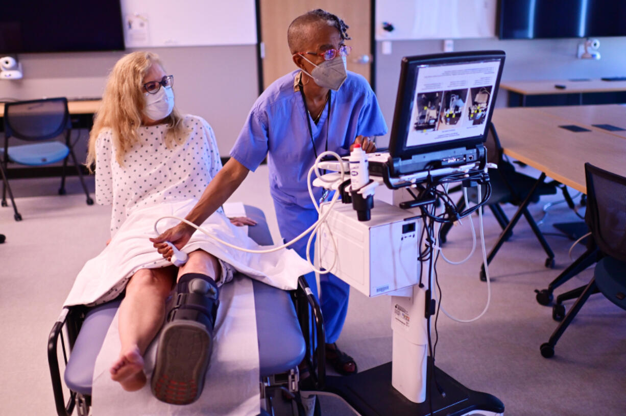 Standardized patients Susan Pierre, left, and Shelley McMillion are in a rehearsal with an ultra sounding system for a planned Simulation Education Project in the Equity multipurpose room of the University of Colorado Anschutz Medical Campus in Aurora, Colo.