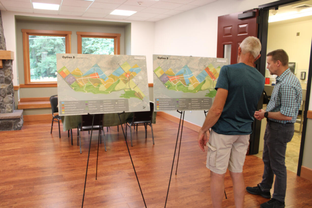 Camas Engineering Manager James Carothers, right, discusses maps showing possible zoning changes in the city's North Shore area, located northeast of Lacamas Lake, during an open house Aug. 17 at Lacamas Lake Lodge in Camas.