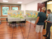 Camas Engineering Manager James Carothers, right, discusses maps showing possible zoning changes in the city's North Shore area, located northeast of Lacamas Lake, during an open house Aug. 17 at Lacamas Lake Lodge in Camas.