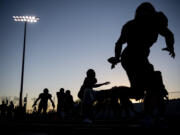 Camas football players warm up Friday, Nov. 5, 2021, before the Papermakers? game against Mount Rainier at Doc Harris Stadium.