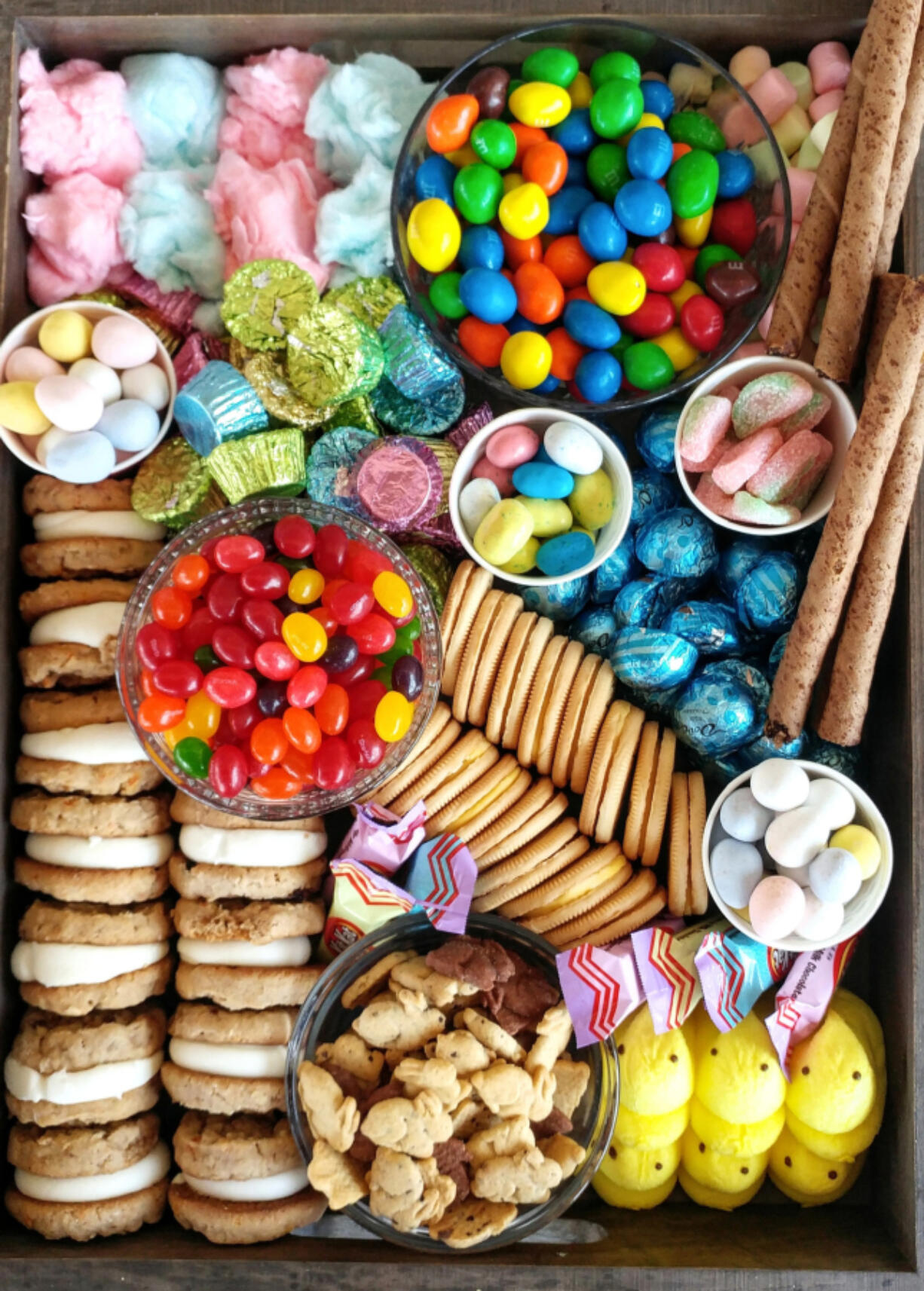 A candy and cookie charcuterie board with Easter candies. Amateur chefs are redefining the term charcuterie itself, adding novel ingredients to their creations.