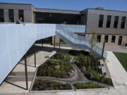 Mike Tokito, communications manager for Evergreen Public Schools, looks over the new courtyard area at Wy'East Middle School. Construction is nearing completion at the building and administrators have started to move in.