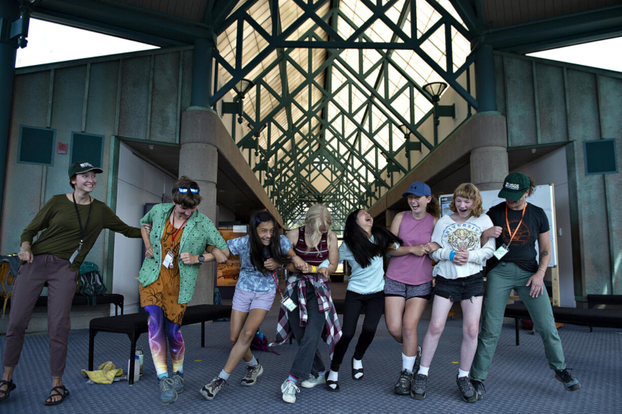 Participants in the GeoGirls outdoor volcano science program summer camp simulate a P wave, one of the types of seismic waves that travel through the earth, at the Coldwater Science and Learning Center on Wednesday morning. The program is for middle- and high-school girls in Southwest Washington. This is the first time the camp has been convened in two years.