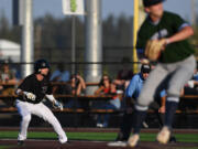 Raptors outfielder Trent Prokes, left, inches toward second base Tuesday, Aug. 9, 2022, during a playoff game between Ridgefield and the Portland Pickles at the Ridgefield Outdoor Recreation Complex.