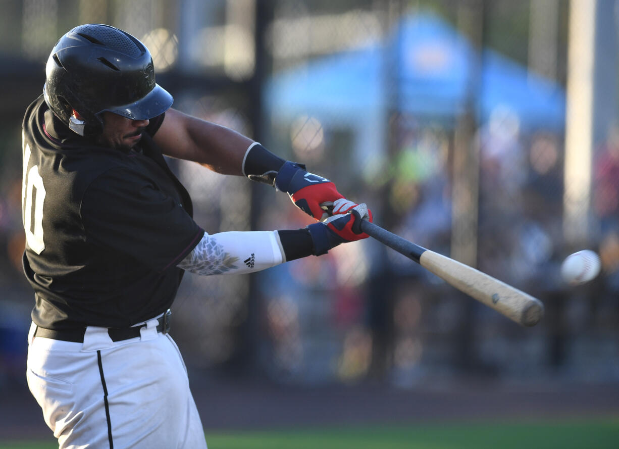 Raptors catcher Isaac Lovings hits the ball Tuesday, Aug. 9, 2022, during a playoff game between Ridgefield and the Portland Pickles at the Ridgefield Outdoor Recreation Complex.