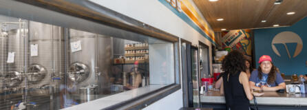 Refrigerated fermentation tanks are visible from Vice Beer's taproom. Some of the tanks are directly connected to tap handles, a rarity in breweries.