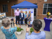 Former Lifeline Connections President and CEO Jared Sanford, from left, former President and CEO Joe Foster, Interim President and CEO Brandy Branch and incoming President and CEO Andrea Brooks pose for a photo Wednesday during a 60th anniversary celebration event for the organization at the Clark County Center for Community Health Building. Sister events were held at three other Lifeline Connections locations across Washington.