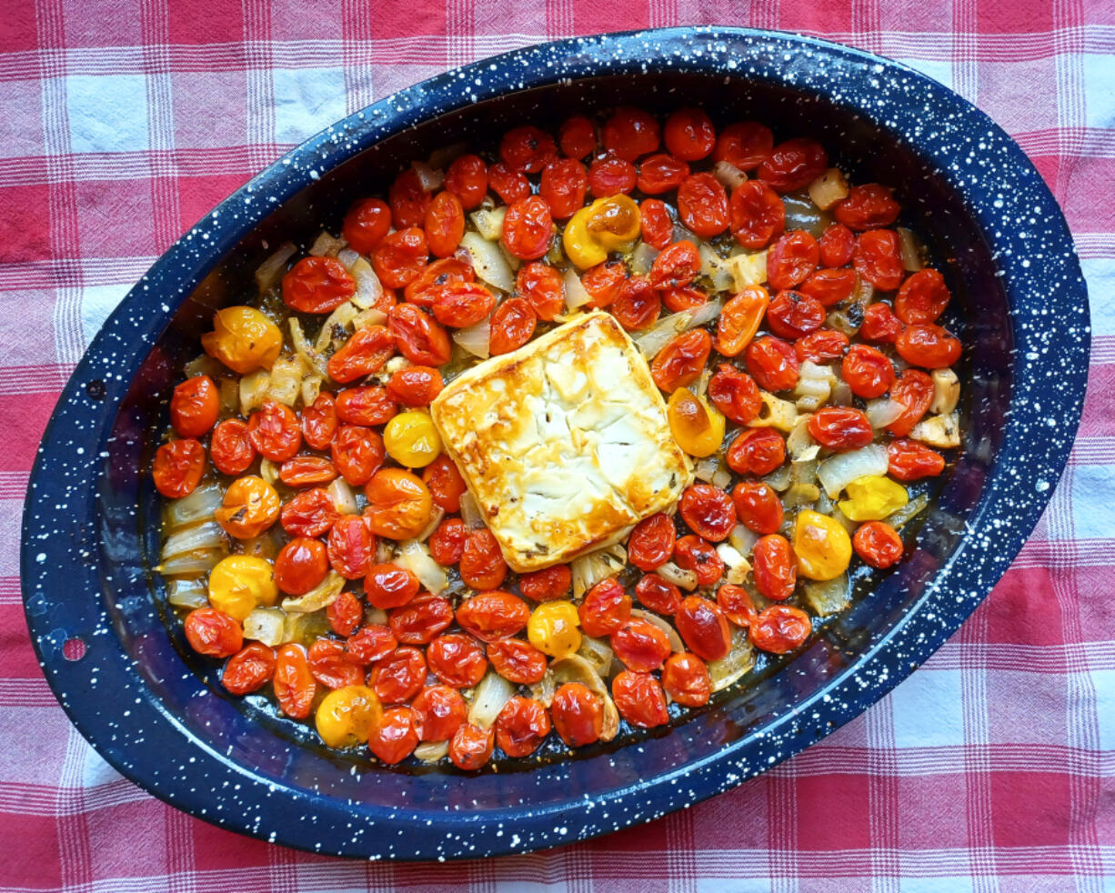 The sauce prep couldn't be simpler -- just put a block of feta cheese in a baking pan with cherry tomatoes, onions and garlic and slather everything in olive oil.