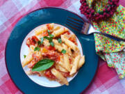 When the feta and tomatoes are done baking, stir them around to make a delectable sauce and mix in your penne and a little water.