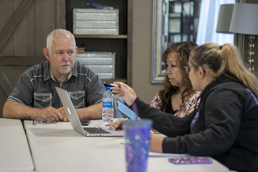 Xchange Recovery's Executive Director Bill Smith, from left, joins program director Vicky Smith and Katie Gayton, executive assistant and foundational community support coordinator, during a staff meeting on Wednesday. Xchange is gearing up for some major expansions this year that will allow the organization to provide its services for people experiencing addiction and homelessness across Clark County. The organization currently operates in Ridgefield and Battle Ground.