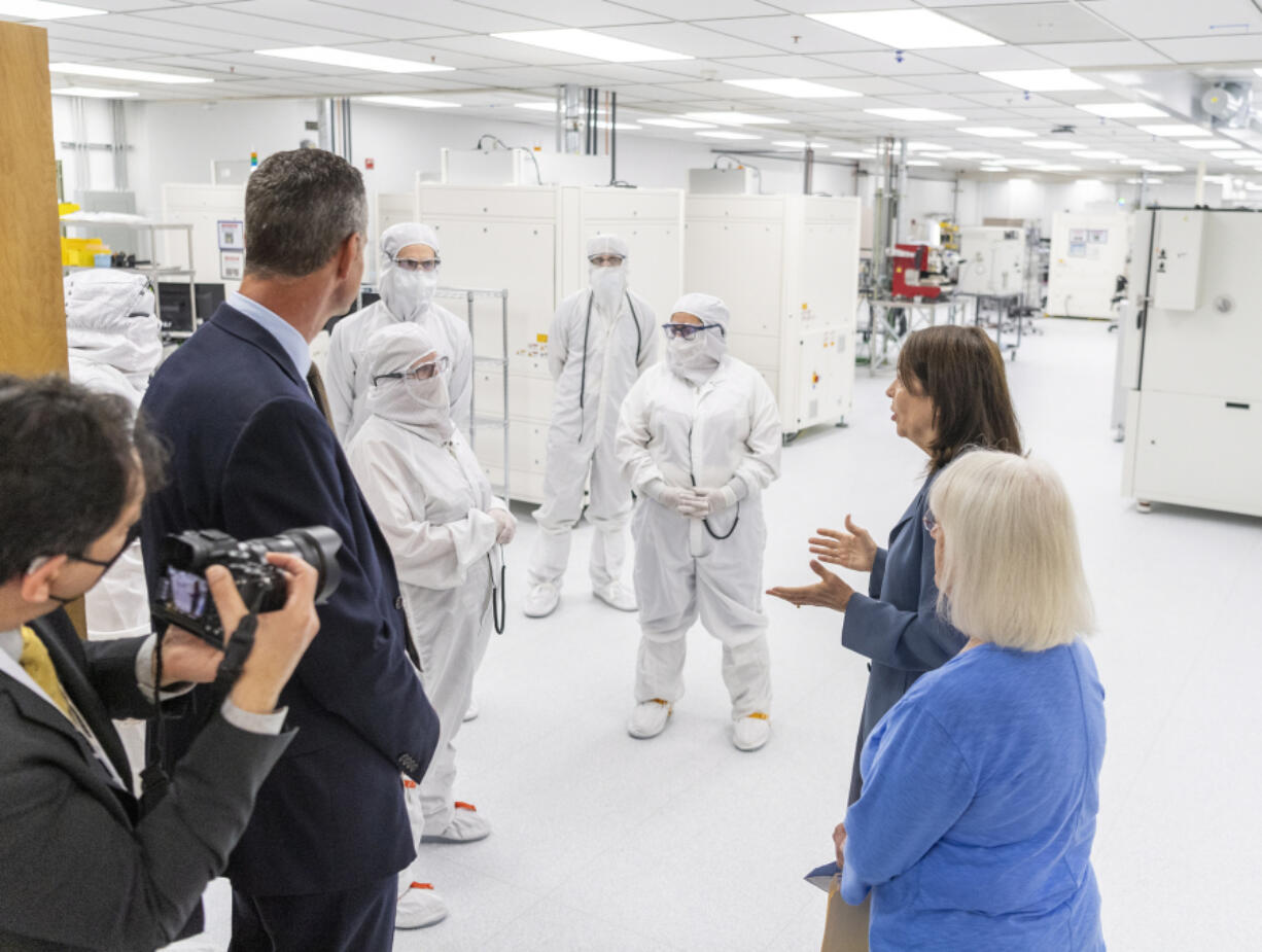 U.S. Sens. Maria Cantwell and Patty Murray talk with nLight employees with CEO Scott Keeney, left, on Wednesday in a clean room at nLight in Camas. Senators Cantwell and Murray were in town to tout the major opportunities coming to Southwest Washington in the recently passed $250 billion CHIPS and Science Act.