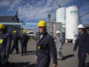 Matthias Zachert, CEO of LANXESS, center, takes a tour of the company's Kalama plant on Monday morning. LANXESS recently purchased Emerald Kalama Chemical for $1.04 billion. The purchase was the second-largest acquisition the company has made.