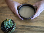 Judd Rench, owner of Bula Kava House, holds a shell of nangol kava in downtown Vancouver.