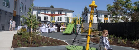 Vancouver Mayor Anne McEnerny-Ogle tests out some of the new playground equipment at Columbia Heights affordable housing complex during its grand opening on Wednesday afternoon.