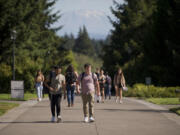 Students make their way to classes with Mount St. Helens in the background at Washington State University Vancouver on Monday.