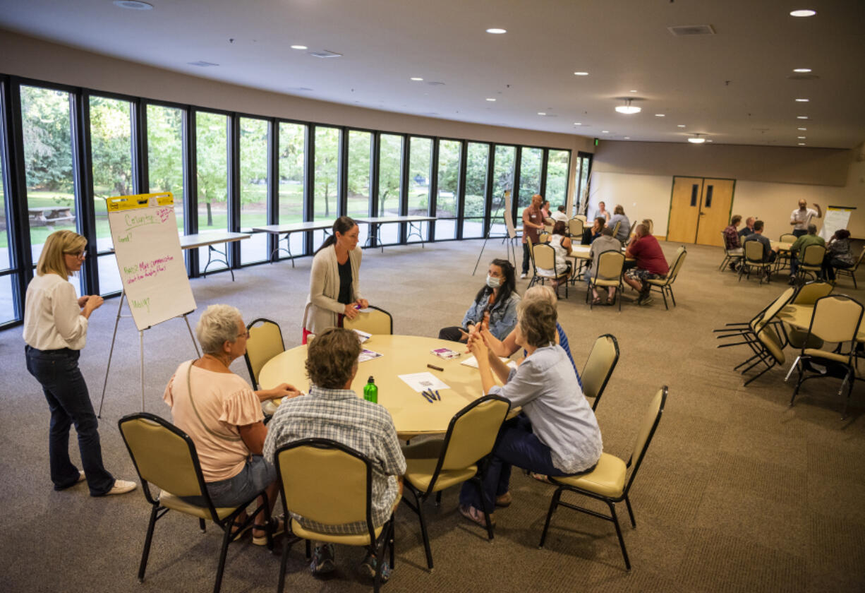 Clark County Treasurer Alishia Topper, third from left, leads a breakout session Tuesday at a community forum at St. Joseph Catholic Church. Community members were invited to provide input on the 2023-2028 Homeless Action Plan for Clark County. The Homeless Action Plan is a road map the county uses to determine how to use funding to serve people experiencing homelessness in Clark County.