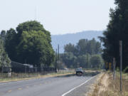 A heat mirage makes the far end of state Highway 501 appear covered in water.  Temperatures in Clark County could hit triple digits and there is a slight chance of thunderstorms putting the region under a fire weather watch.