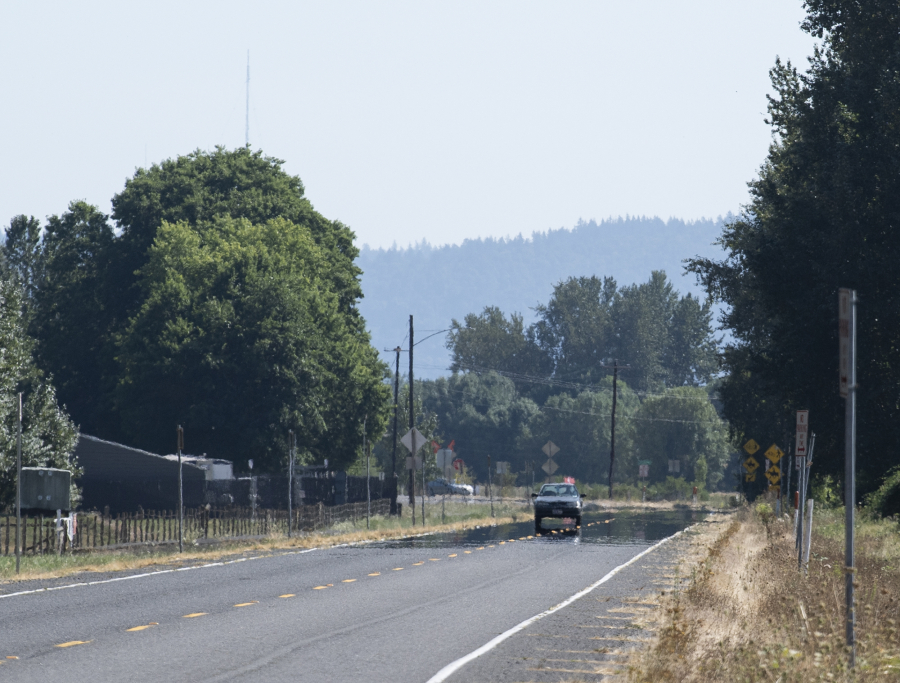 A heat mirage makes the far end of state Highway 501 appear covered in water.  Temperatures in Clark County could hit triple digits and there is a slight chance of thunderstorms putting the region under a fire weather watch.