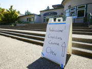 A sign showing that a cooling center at the Charles Jordan Community Center is open is shown in Portland on July 26. Temperatures are expected to top 100 degrees on Tuesday and wide swaths of western Oregon and Washington are predicted to be well above historic averages throughout the week.