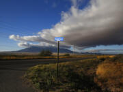 FILE - A street sign leads to what was once the home of Paul Adams and his family on the outskirts of Bisbee, Ariz., on Oct 26, 2021.