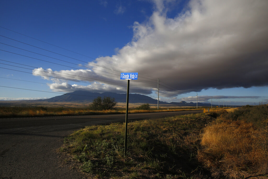 FILE - A street sign leads to what was once the home of Paul Adams and his family on the outskirts of Bisbee, Ariz., on Oct 26, 2021.