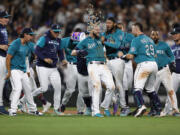 Seattle Mariners' Mitch Haniger celebrates his RBI single to win 3-2 against the Cleveland Guardians during the 11th inning of a baseball game, Friday, Aug. 26, 2022, in Seattle.