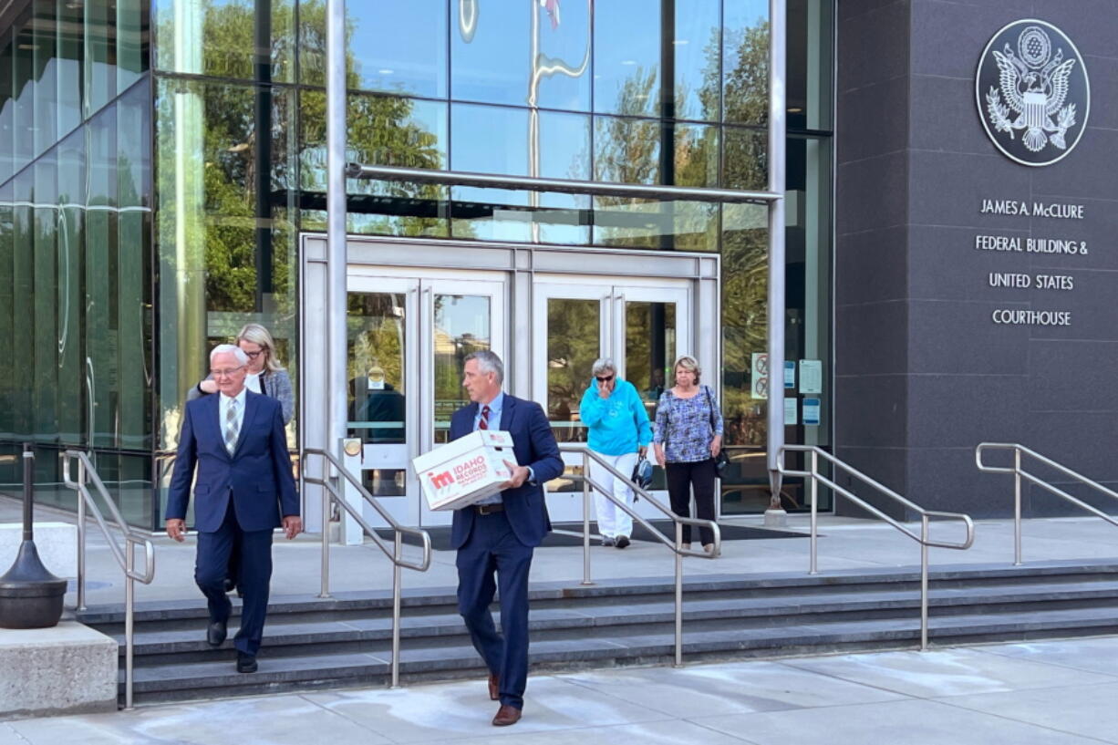 Attorneys Monte Stewart, left, and Daniel Bower, center, leave the James A. McClure Federal Building and Courthouse in Boise, Idaho, after oral arguments in a lawsuit brought by the U.S. Department of Justice against Idaho over the states near-total abortion ban on Monday, Aug. 22, 2022. Stewart and Bower are representing the Idaho Legislature, which contends the state's ban doesn't violate federal law governing emergency health care treatment in Medicare-funded hospitals.