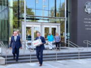 Attorneys Monte Stewart, left, and Daniel Bower, center, leave the James A. McClure Federal Building and Courthouse in Boise, Idaho, after oral arguments in a lawsuit brought by the U.S. Department of Justice against Idaho over the states near-total abortion ban on Monday, Aug. 22, 2022. Stewart and Bower are representing the Idaho Legislature, which contends the state's ban doesn't violate federal law governing emergency health care treatment in Medicare-funded hospitals.