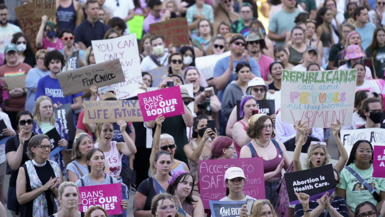 FILE - In this Friday, June 24, 2022, file photo, abortion rights protesters cheer at a rally following the United States Supreme Court's decision to overturn Roe v. Wade, federally protected right to abortion, outside the state capitol in Lansing, Mich. The Michigan Court of Appeals ruled Monday, Aug. 1, 2022, that county prosecutors can enforce the state's 91-year-old abortion ban, paving the way for abortion to become illegal in parts of the state.