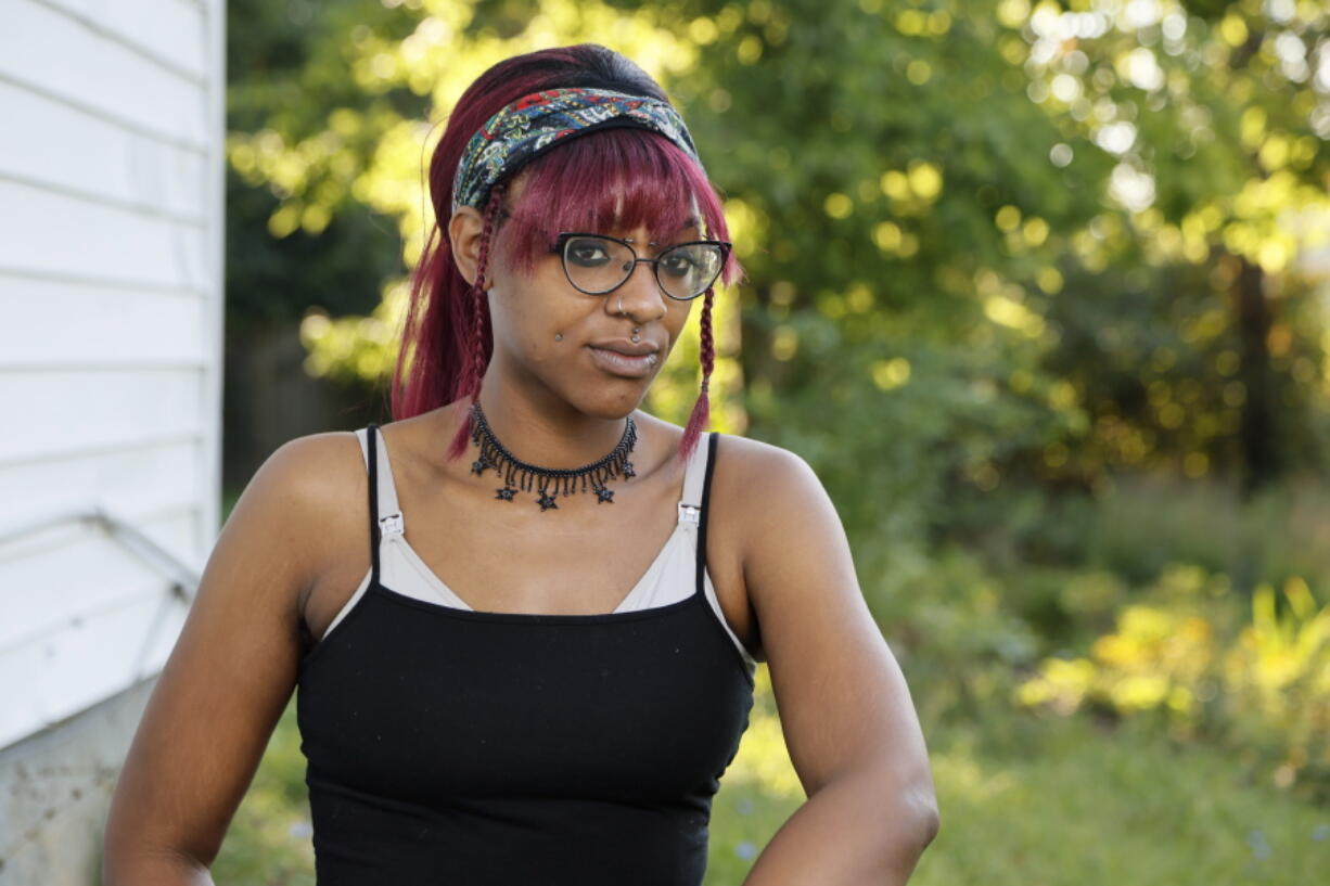 Monica Eberhart sits outside her home Thursday, Aug. 25, 2022, in Columbus, Ohio. Eberhart had to travel to Indianapolis, Ind., for an abortion after Ohio imposed a ban on abortions once fetal heart activity could be detected.