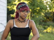 Monica Eberhart sits outside her home Thursday, Aug. 25, 2022, in Columbus, Ohio. Eberhart had to travel to Indianapolis, Ind., for an abortion after Ohio imposed a ban on abortions once fetal heart activity could be detected.