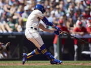 Seattle Mariners' Jesse Winker hits a grand slam against the Los Angeles Angels on a pitch from Tucker Davidson during third inning of a baseball game, Sunday, Aug. 7, 2022, in Seattle.