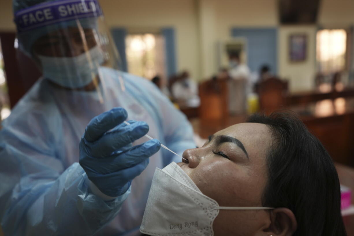 A journalist receives a COVID-19 test before covering the 55th ASEAN Foreign Ministers' Meeting (55th AMM) in Phnom Penh, Cambodia, Tuesday, Aug. 2, 2022. Southeast Asian foreign ministers are gathering in the Cambodian capital for meetings addressing persisting violence in Myanmar and other issues, joined by top diplomats from the United States, China, Russia and other world powers amid tensions over the invasion of Ukraine and concerns over Beijing's growing ambitions in the region.