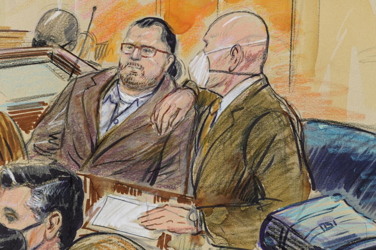 FILE - This artist sketch depicts Guy Wesley Reffitt, joined by his lawyer William Welch, right, in Federal Court, in Washington, on Feb. 28, 2022.  Reffitt, convicted of storming the U.S. Capitol with a holstered handgun helmet and body armor was sentenced on Monday to 87 months -- more than seven years -- in prison. It's the longest sentence imposed so far among hundreds of Capitol riot cases.