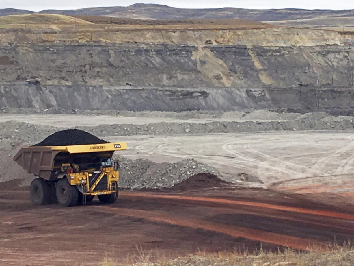 FILE - In this March 28, 2017 file photo, a dump truck hauls coal at Contura Energy's Eagle Butte Mine near Gillette, Wyo.  A judge has ruled U.S. government officials engaged in regional-level planning failed to follow a court order requiring them to consider allowing less coal to be mined as a way to fight climate change. The Wednesday, Aug. 3, 2022 ruling by U.S. District Judge Brian Morris in Great Falls, Montana, applies to the country's top coal-producing region, the Powder River Basin of Wyoming and Montana.