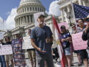 Veterans, military family members and advocates are joined by activist Jon Stewart as they call for Senate Republicans to change their votes on a bill designed to help millions of veterans exposed to toxic substances during their military service, at the Capitol in Washington, Monday, Aug. 1, 2021. A bill that enhances health care and disability benefits for millions of veterans exposed to toxic burn pits has hit a snag in the Senate. (AP Photo/J.