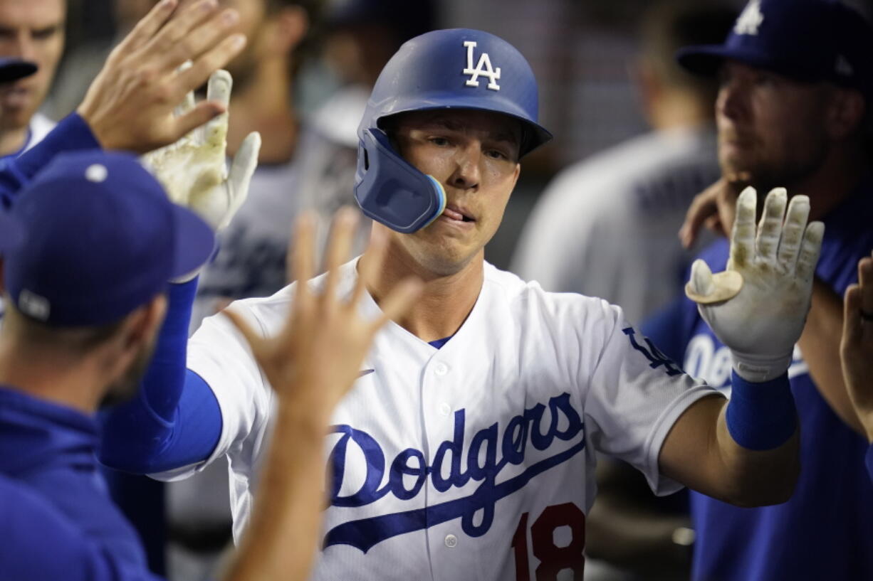 Los Angeles Dodgers' Jake Lamb (18) returns to the dugout after hitting a home run during the seventh inning of a baseball game against the Chicago Cubs in Los Angeles, Saturday, July 9, 2022.