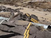 In this photo released by the National Park Service, is the damaged intersection of Kelbacker Road and Mojave Road in the Mojave National Preserve, Calif., Sunday, July 31, 2022. Roads in and out of Death Valley National Park were closed after lanes mud and debris inundated lanes during weekend flash floods in eastern California, western Nevada and northern Arizona. Storm cells dumped localized heavy rain across the region, prompting closures of highways and campgrounds.