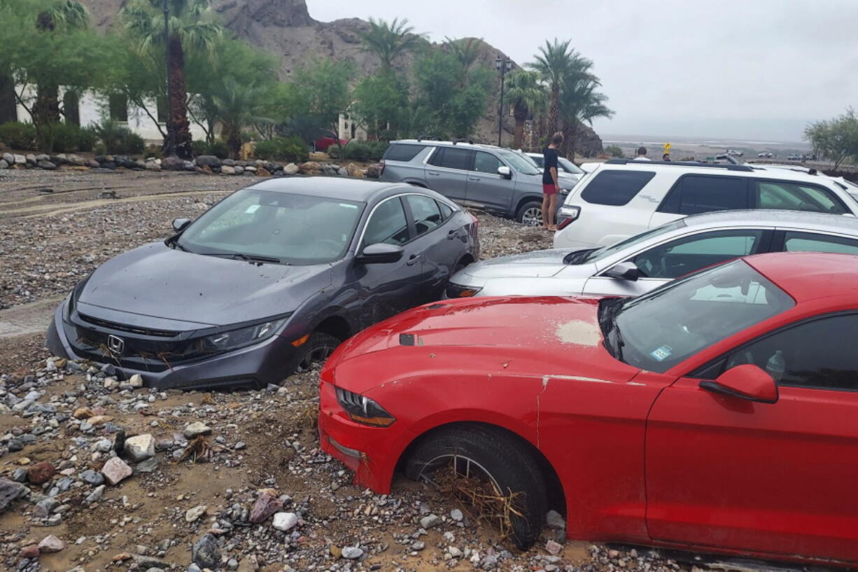 In this photo provided by the National Park Service, cars are stuck in mud and debris from flash flooding at The Inn at Death Valley in Death Valley National Park, Calif., Friday, Aug. 5, 2022. Heavy rainfall triggered flash flooding that closed several roads in Death Valley National Park on Friday near the California-Nevada line. The National Weather Service reported that all park roads had been closed after 1 to 2 inches of rain fell in a short amount of time.