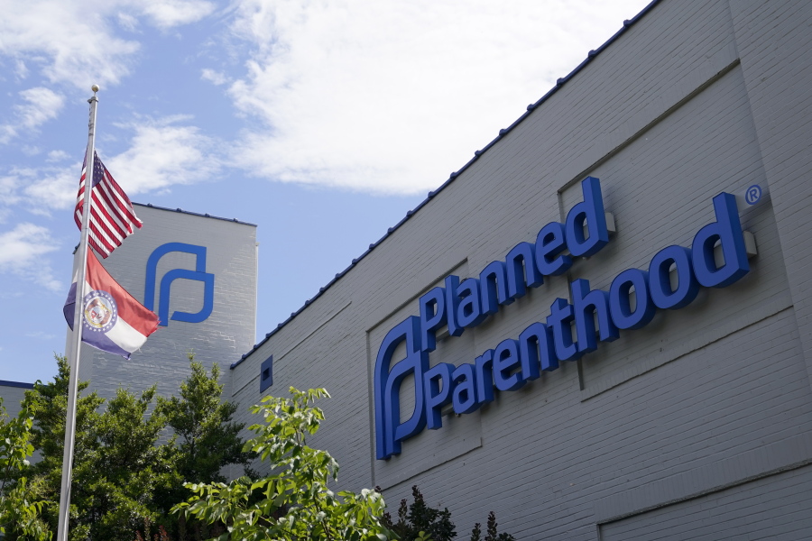 FILE - Missouri and American flags fly outside Planned Parenthood June 24, 2022, in St. Louis. Planned Parenthood, the nation's leading reproductive health care provider and abortion rights advocacy organization, plans to spend a record $50 million ahead of November's midterm elections, pouring money into contests where access to abortion will be on the ballot.