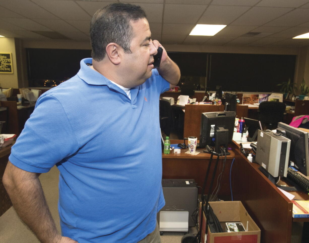 FILE - Pueblo County Clerk Gilbert "Bo" Ortiz checks the status of voting machines that apparently failed to work correctly, causing long delays in election results being released on Nov, 8, 2016 in Pueblo, Colo. In Pueblo County, election officials are preparing for every possibility during the November general election. Ortiz oversees elections as the clerk and recorder in Pueblo County, which Donald Trump narrowly won in 2016 but lost four years later.