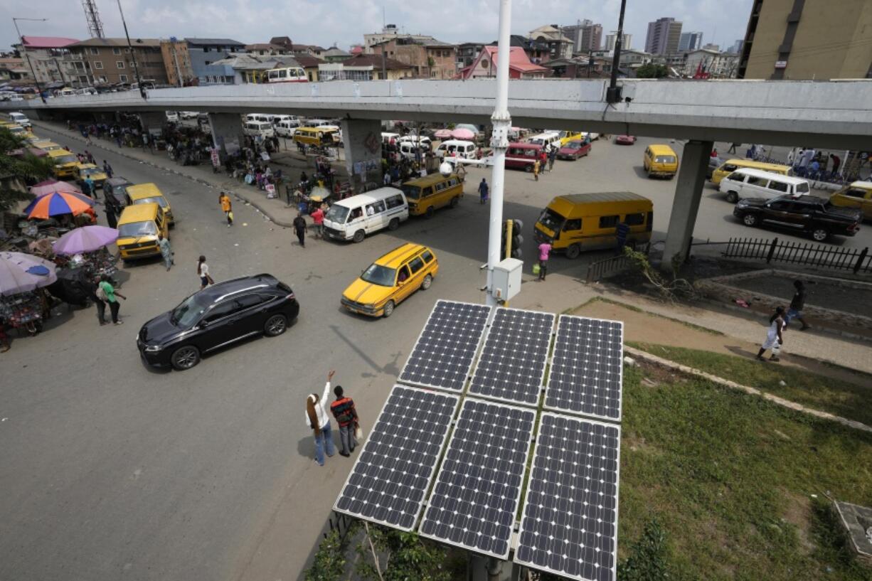 Solar panels sit near a street in the Obalende neighborhood of Lagos, Nigeria, Saturday, Aug. 20, 2022. Access to more and cleaner energy while continuing to grow economically will be a top priority for African nations in the upcoming United Nations climate conference in November, top officials and climate experts on the continent said.