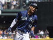 Seattle Mariners' Julio Rodriguez celebrates while rounding the bases a three-run home run by Mitch Haniger during the first inning a baseball game against the Cleveland Guardians, Thursday, Aug. 25, 2022, in Seattle.