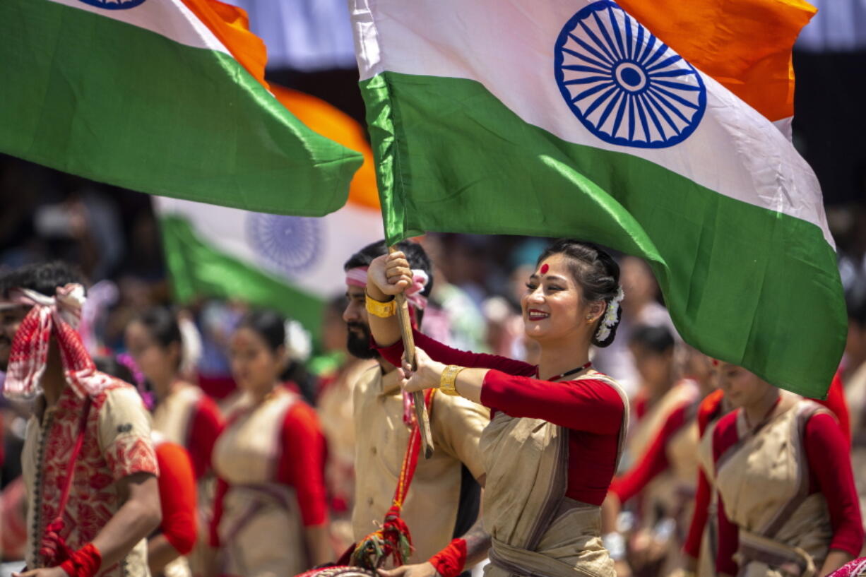 Assamese girls and boys in traditional attire carry Indian flags as they perform Bihu dance on Independence Day in Gauhati, northeastern Assam state, India, Monday, Aug. 15, 2022. The country is marking the 75th anniversary of its independence from British rule.